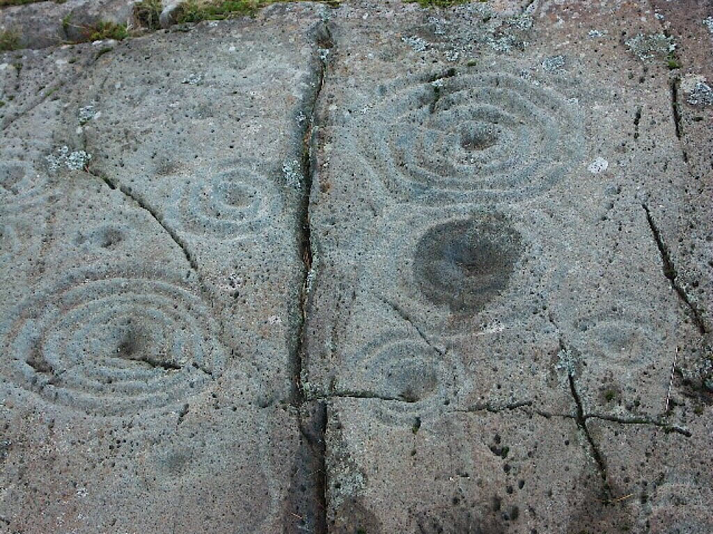 Cup and Ring Marks on a Stone near Cairnbaan Scotland. Wikipedia